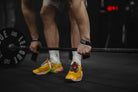 Lifting straps attached to a barbell